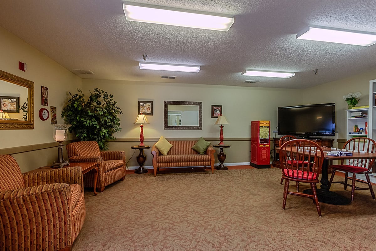 A cozy living room with comfortable seating and warm lighting.