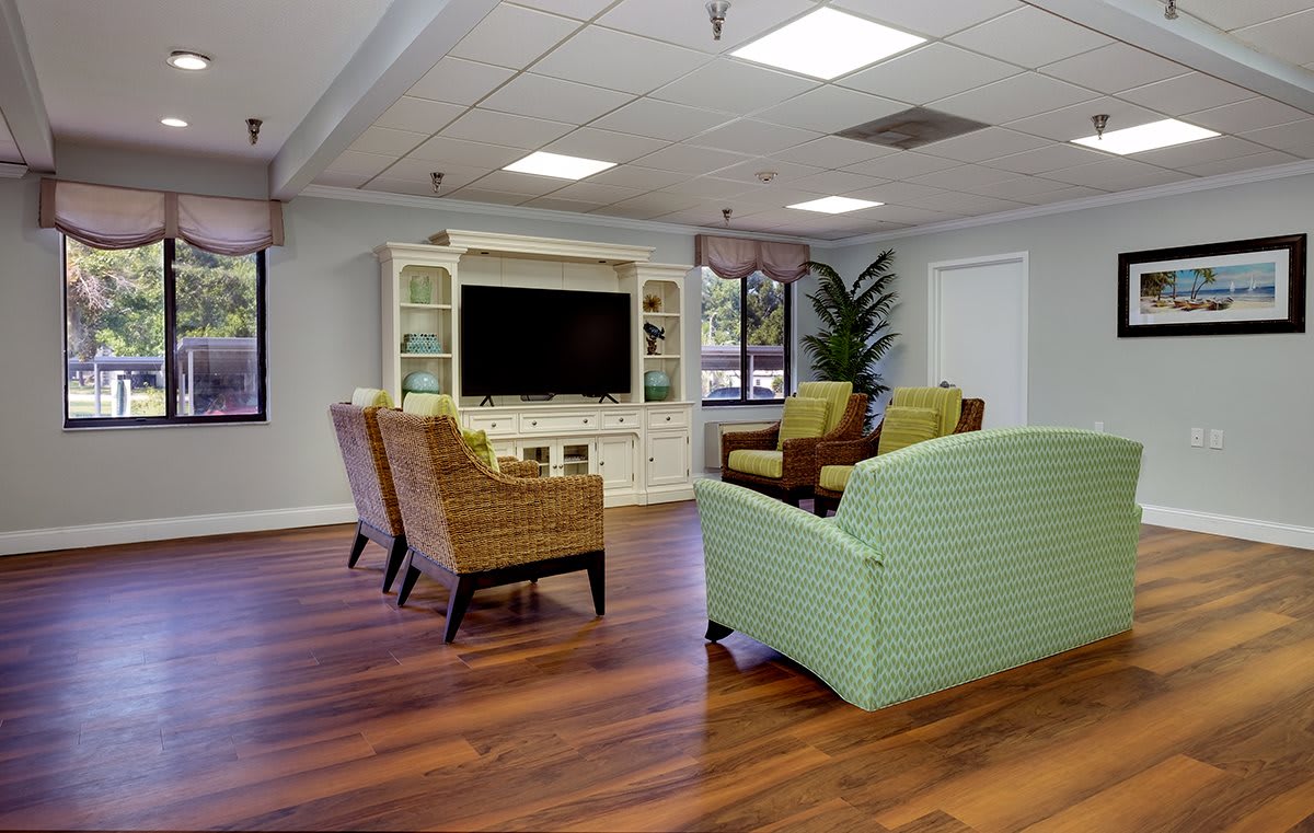 A cozy living room with comfortable seating and a large television.