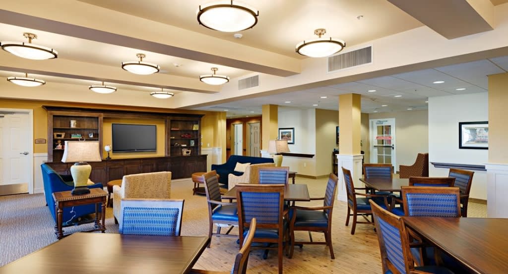 A spacious and well-lit community lounge area with comfortable seating and modern decor.
