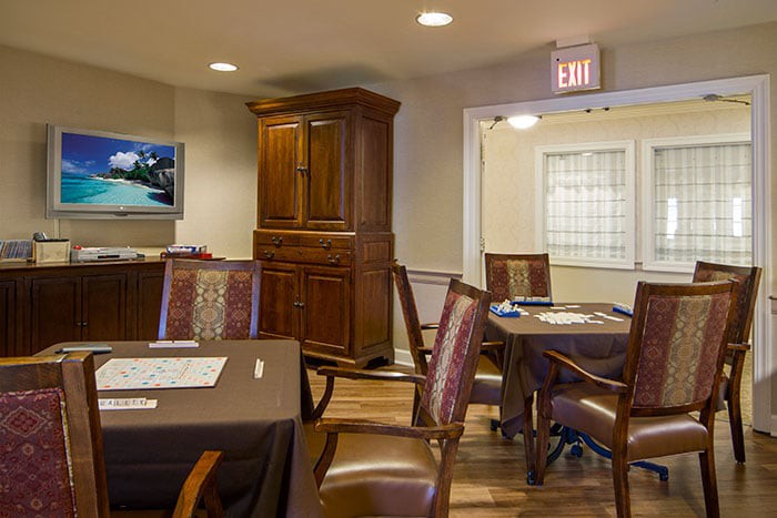 A cozy dining area with wooden furniture and warm lighting.