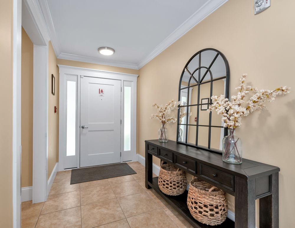 A welcoming entryway featuring a console table with decorative elements and a mirror.