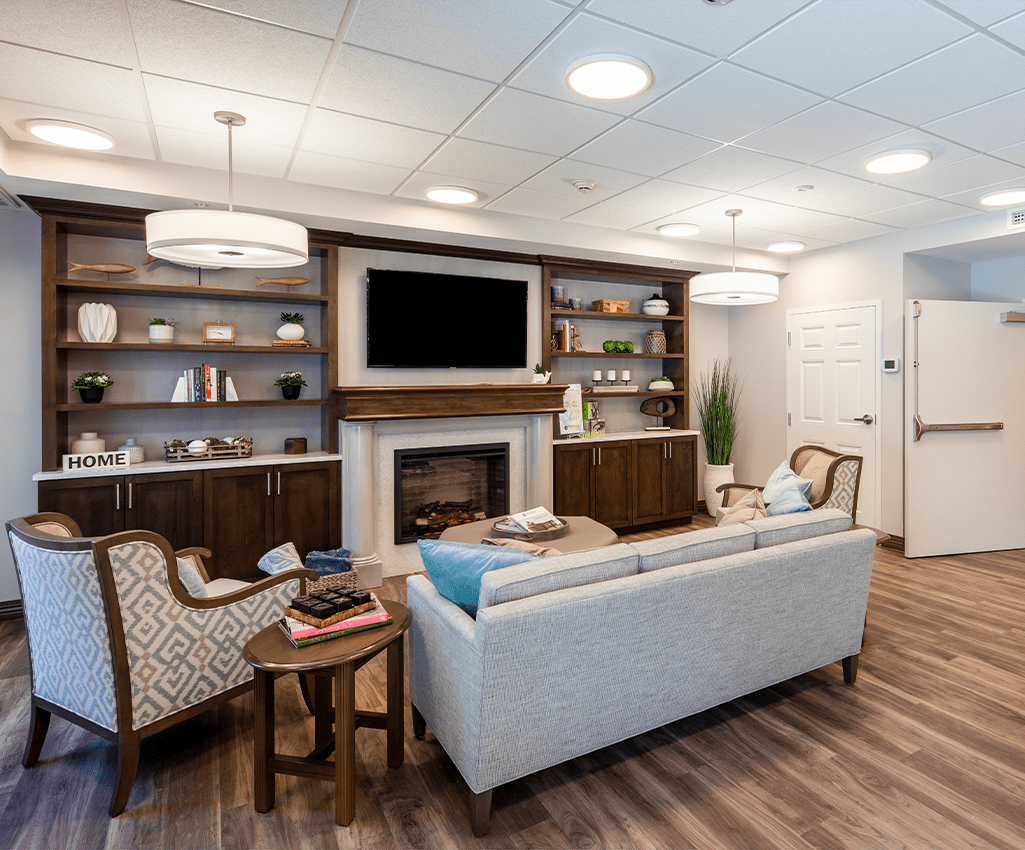 A modern living room with a cozy fireplace, stylish furniture, and elegant decor.