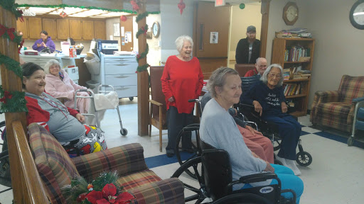 Residents enjoying a social gathering in a care facility during the winter season.