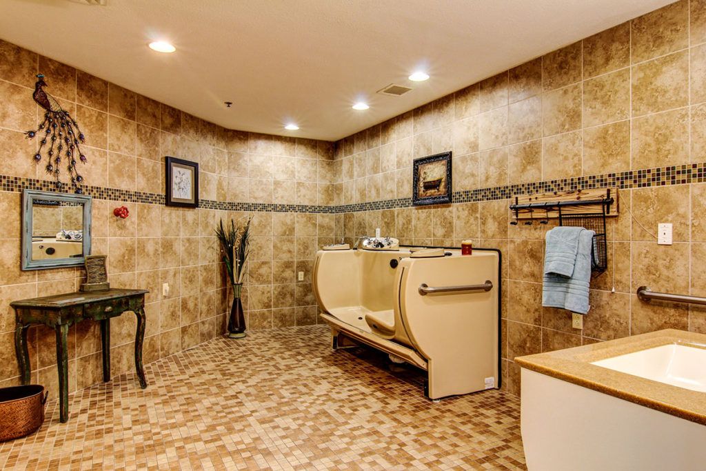 A spacious and luxurious bathroom with elegant tile work and furnishings.