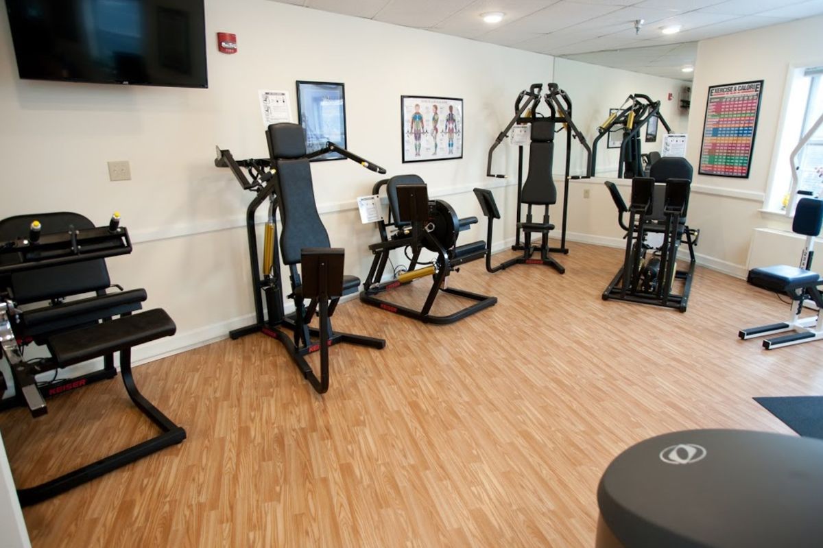 A compact gym with various exercise machines for fitness enthusiasts.