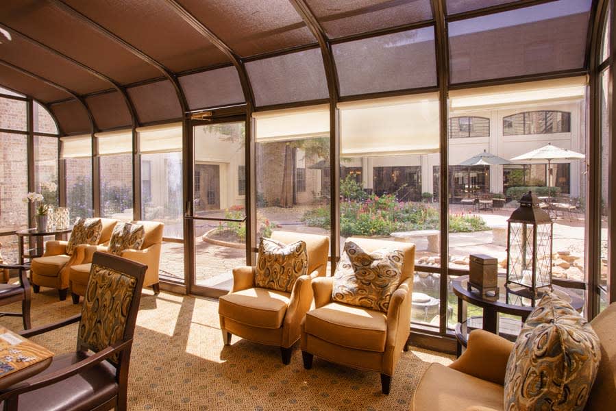 A cozy lounge area with plush chairs and large windows allowing natural light to fill the space.
