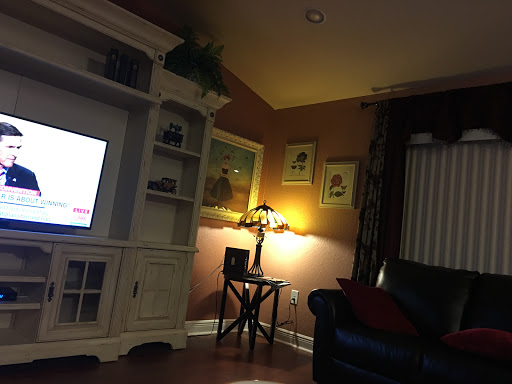 A cozy living room setting with warm lighting and comfortable furniture.