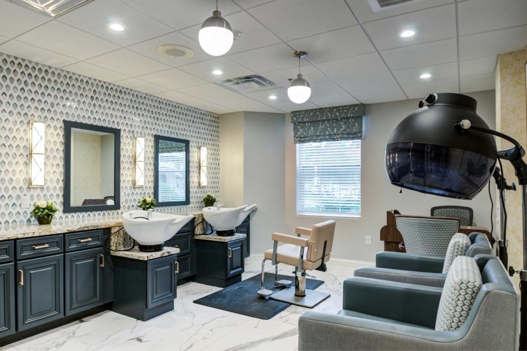 A modern hair salon interior with stylish chairs, sinks, and mirrors.