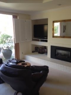 A cozy living room with a fireplace, TV, and comfortable seating.