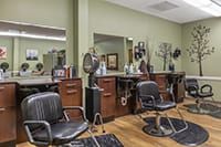 A modern hair salon interior with styling chairs and professional equipment.