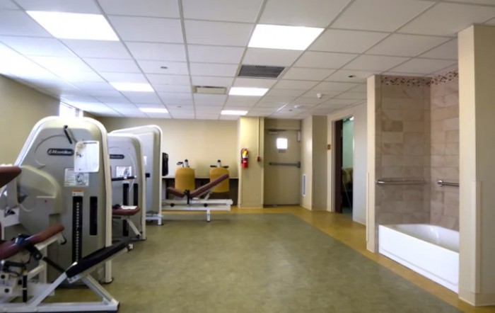 A spacious gym interior with various exercise equipment.
