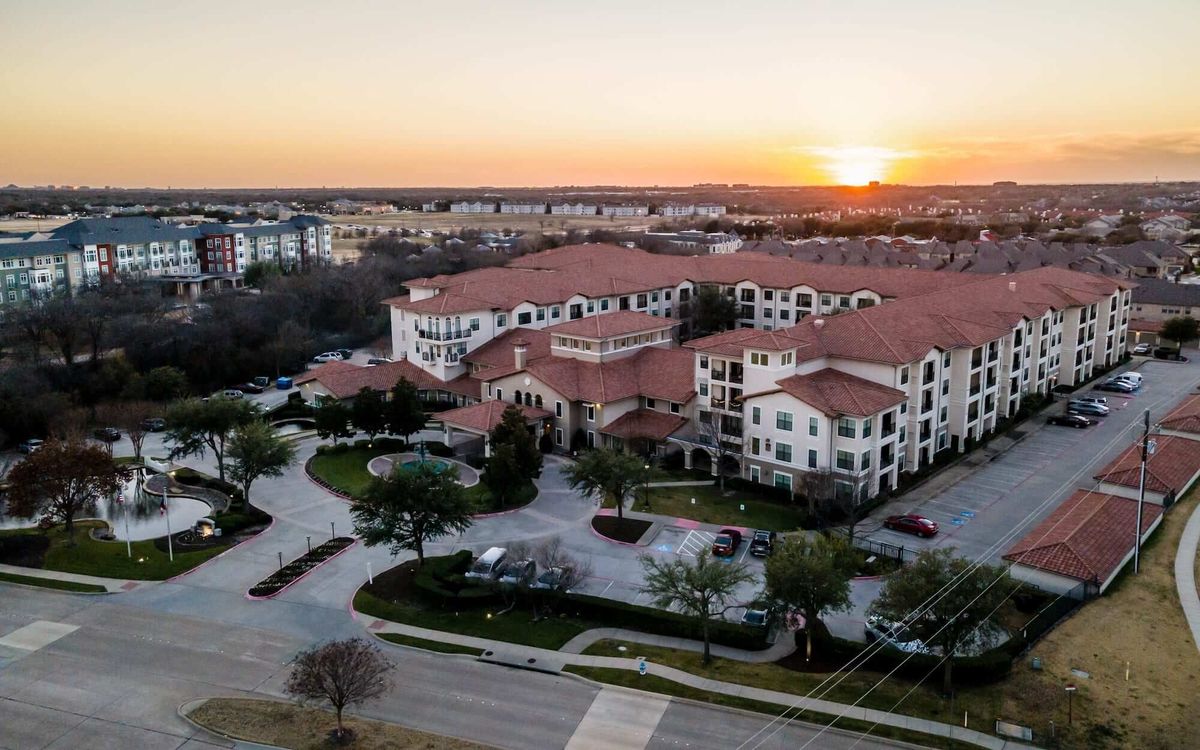 Aerial view of a residential complex at sunset.