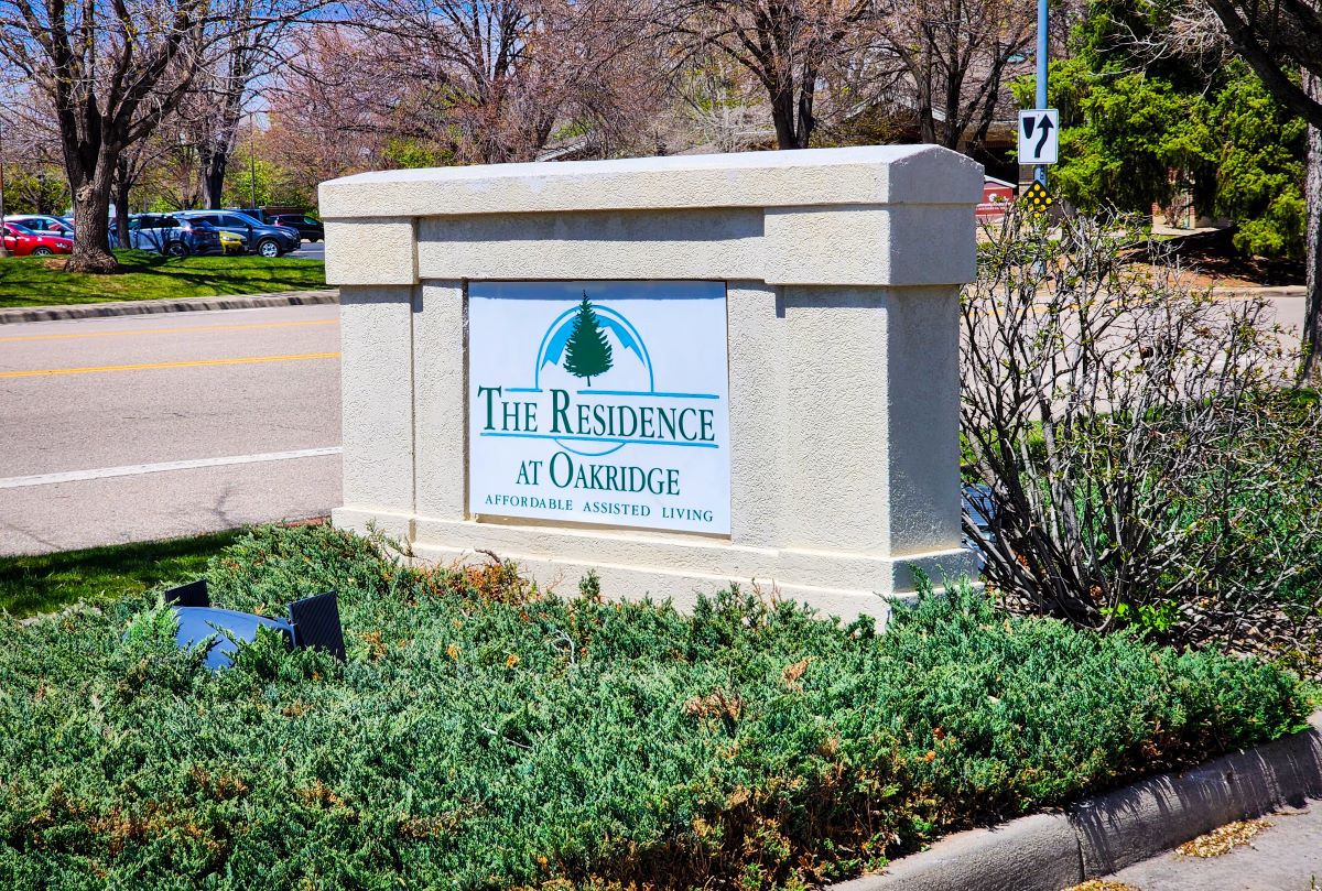 Entrance sign for The Reserve at Glenridge, located near a road surrounded by greenery.