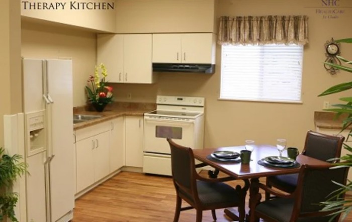 A cozy kitchen with a dining table set and modern appliances.