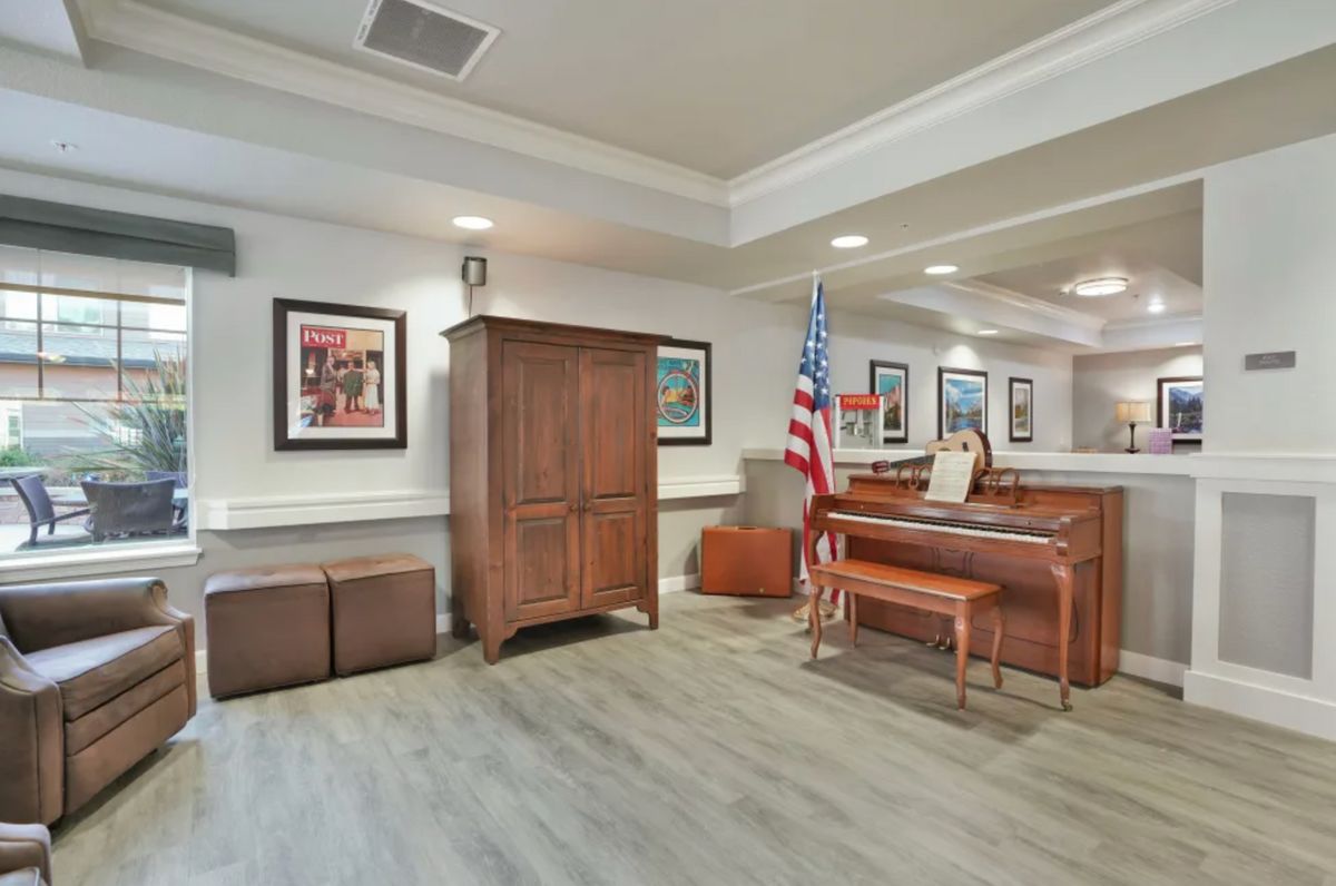 A courtroom with wooden furniture and an American flag.