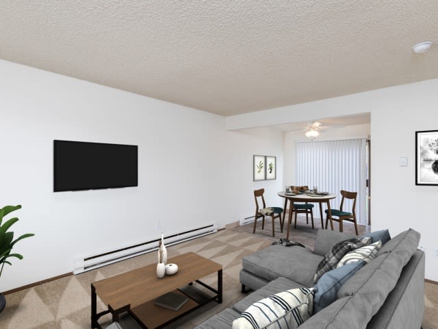 A modern, minimalist living room with a dining area in the background.