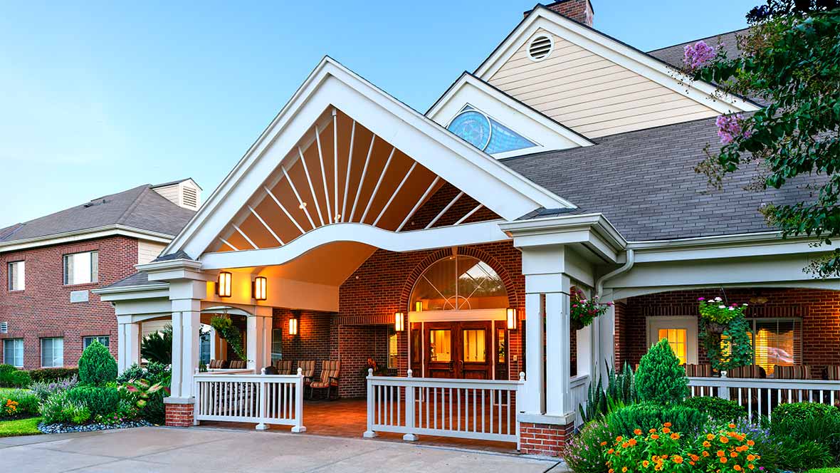 Front entrance of a residential building with a peaked roof and welcoming porch.