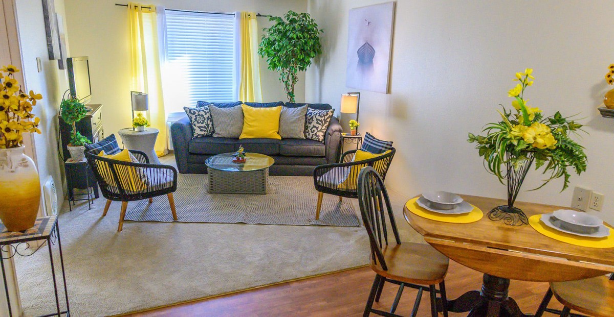 A stylish living room with modern furniture and bright yellow accents.