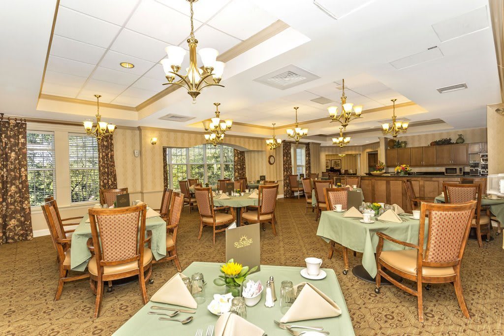 Elegant dining room interior with neatly arranged tables and classic decor.