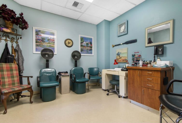 A cozy hair salon interior featuring styling chairs and hair dryers.