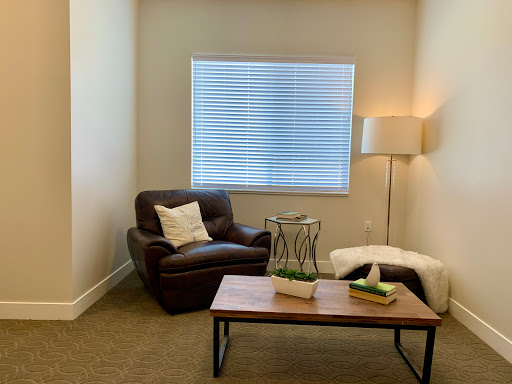 A cozy corner in a modern living space featuring a comfortable armchair, stylish coffee table, and soft lighting.