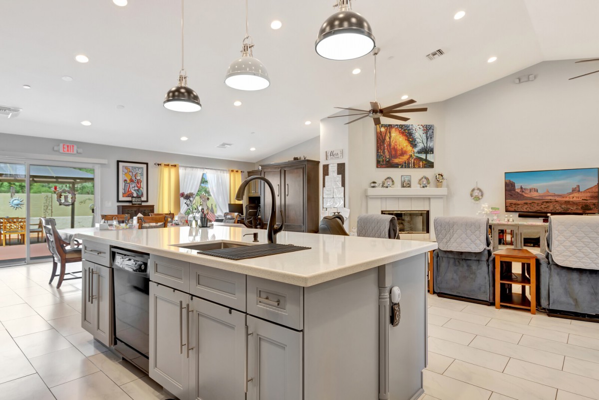 Modern open-concept kitchen with a central island and pendant lighting.