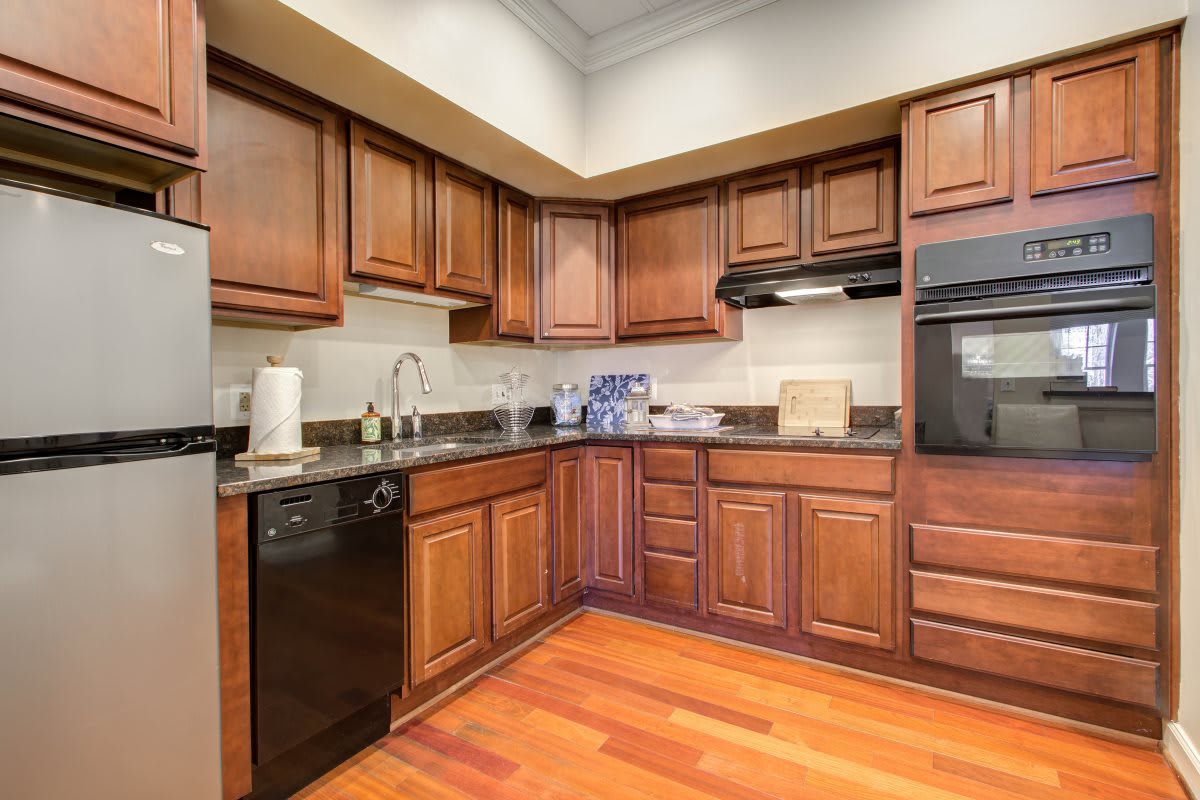 A modern kitchen featuring wooden cabinets, various appliances, and a clean countertop.
