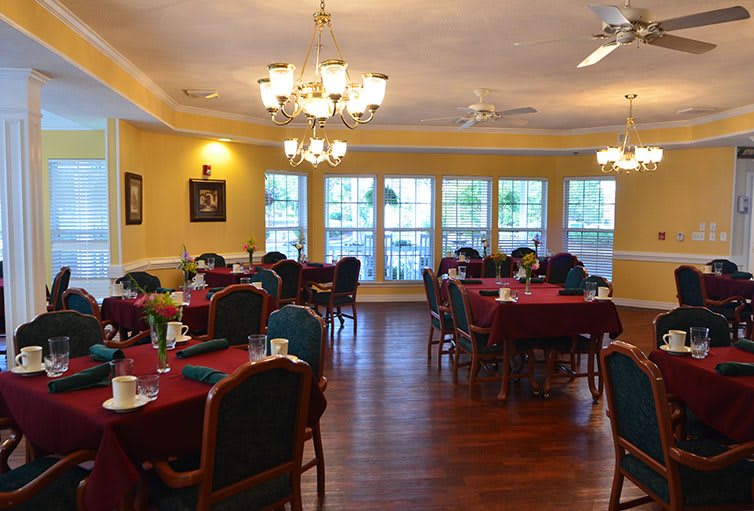 A cozy dining area with elegantly set tables and warm lighting.