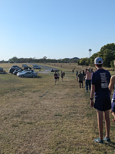Participants walk along a path during an outdoor running event.