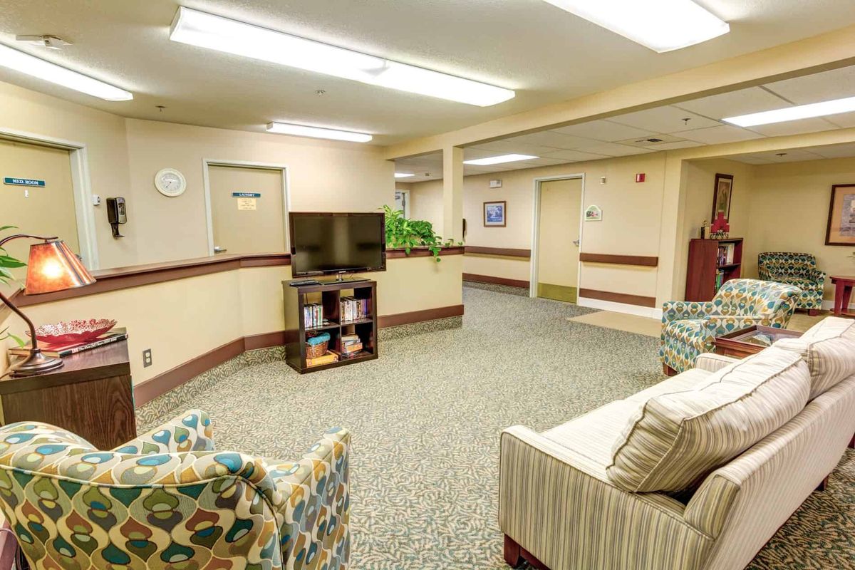 A cozy waiting area with comfortable seating and a television.
