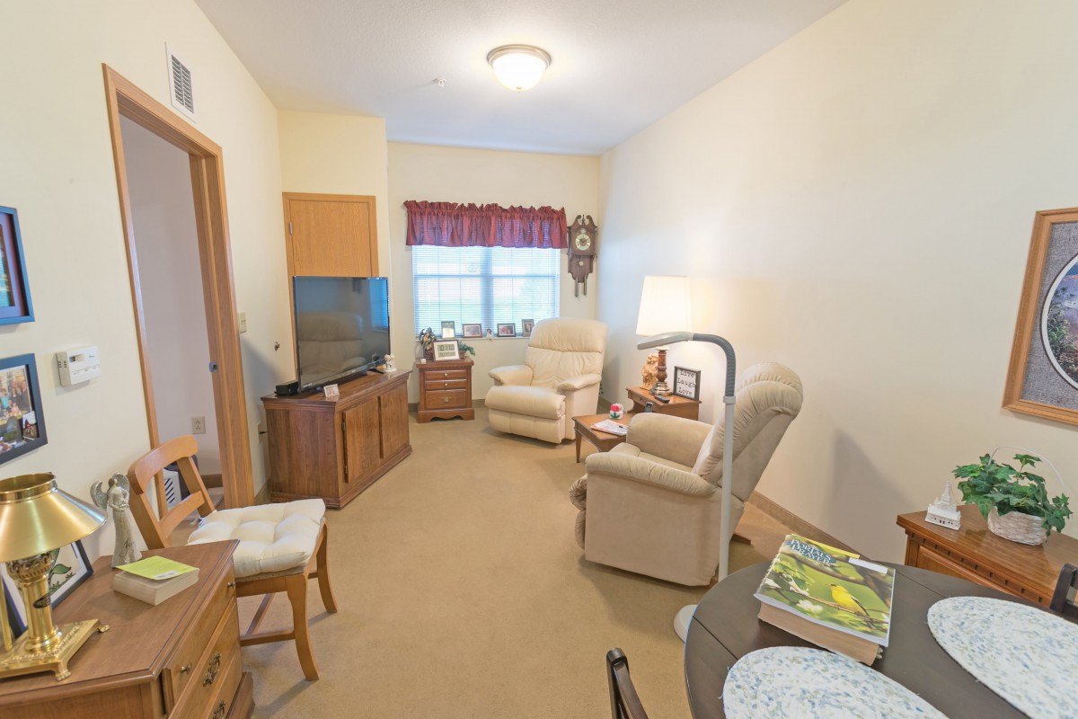 A cozy living room with comfortable armchairs and a TV.