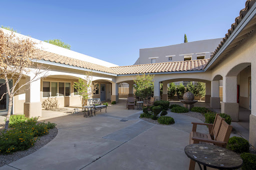 A serene courtyard featuring a blend of architectural elements and well-maintained landscaping, perfect for relaxation.