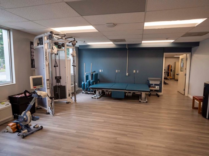 A clean and organized gym space with exercise equipment.