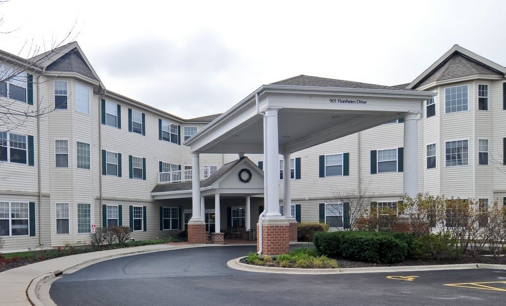 An exterior view of a residential building with a covered entrance and driveway.