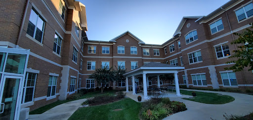 A modern residential building featuring a well-maintained exterior and landscaped garden.