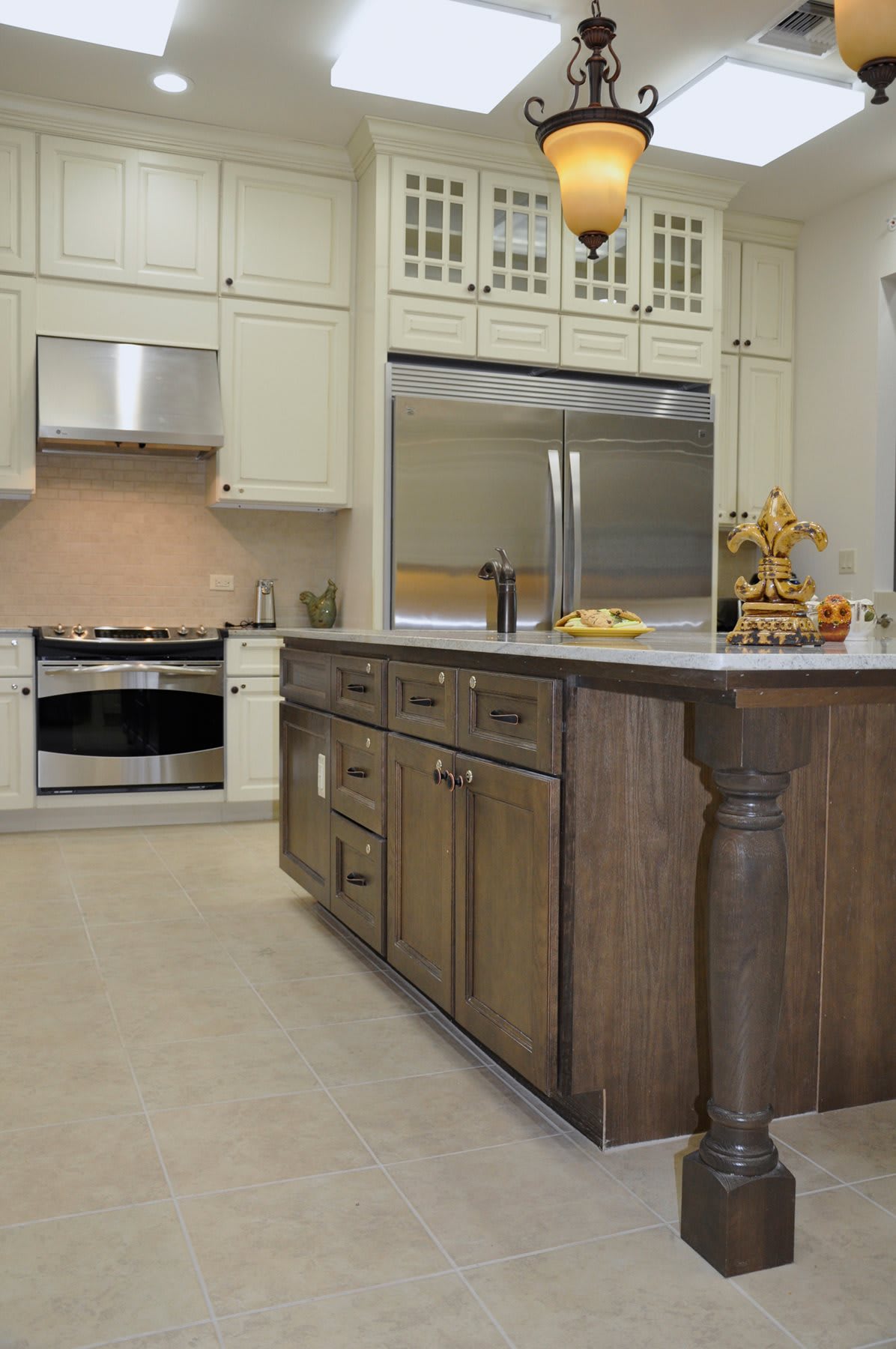 A modern kitchen with a large island and stainless steel appliances.