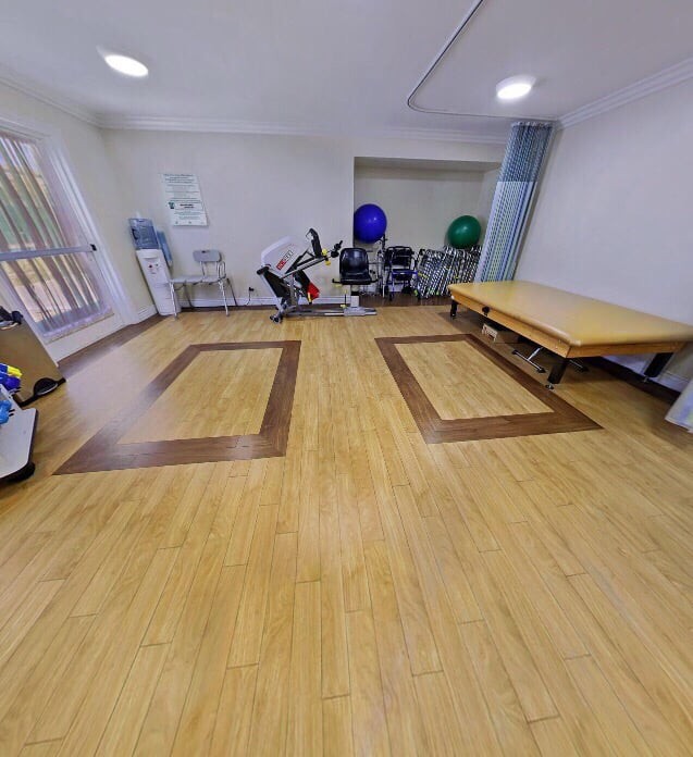 An empty exercise room equipped for physical therapy.