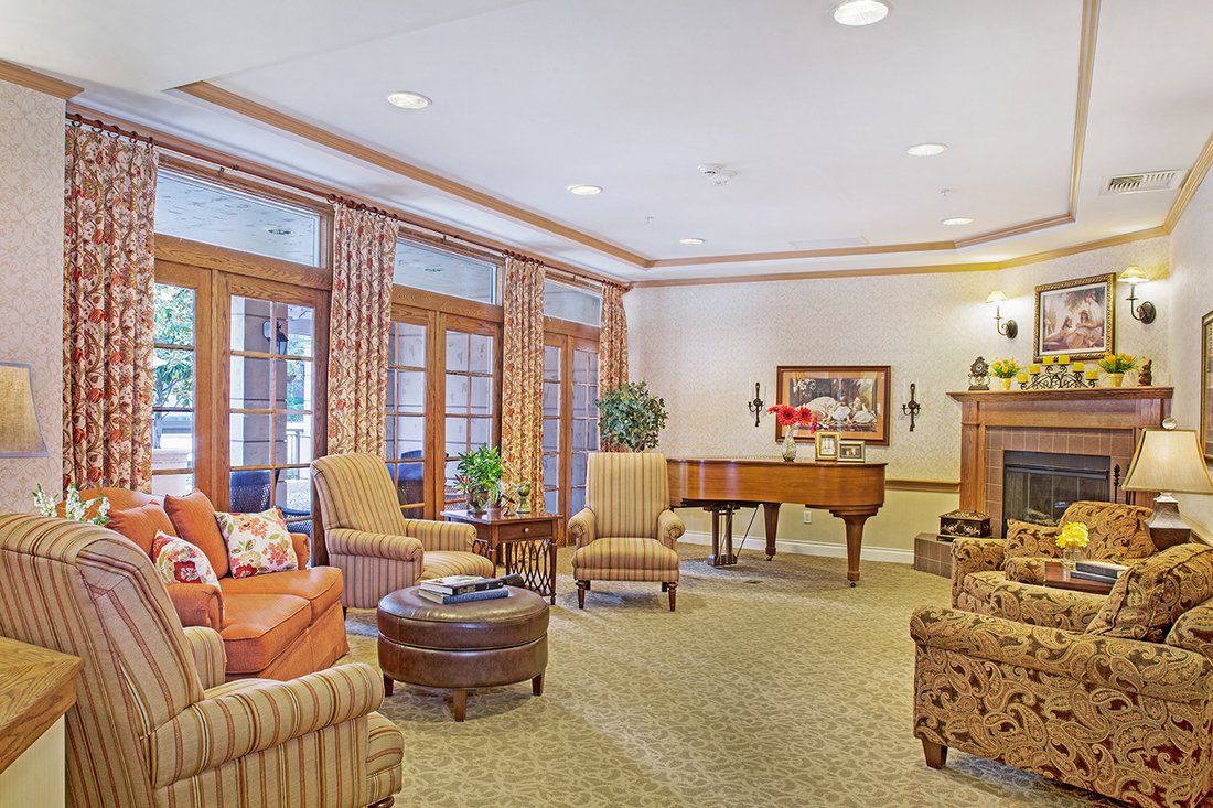 A cozy lounge area featuring comfortable seating and a grand piano.