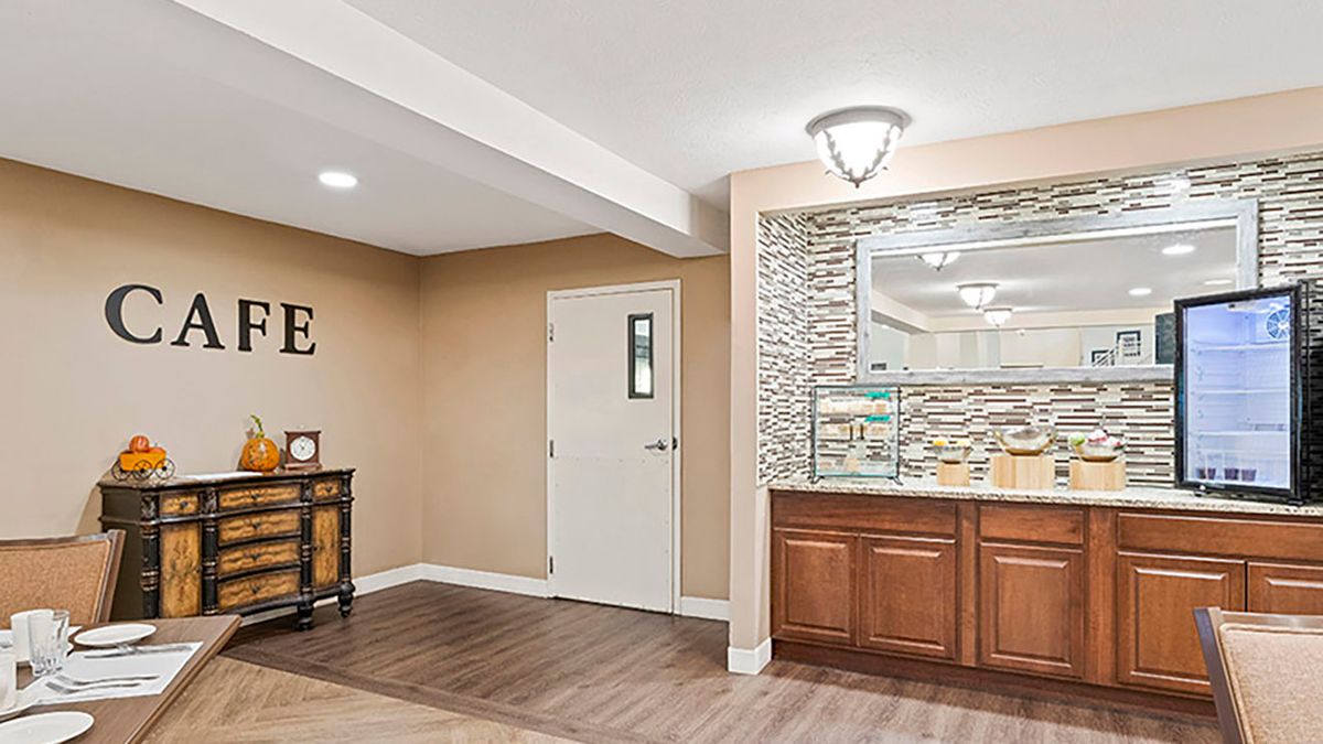A modern interior room with wooden flooring, featuring a decorative wall and built-in cabinet.