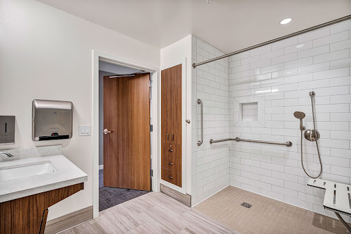 A modern, accessible bathroom featuring a spacious shower area and contemporary fixtures.