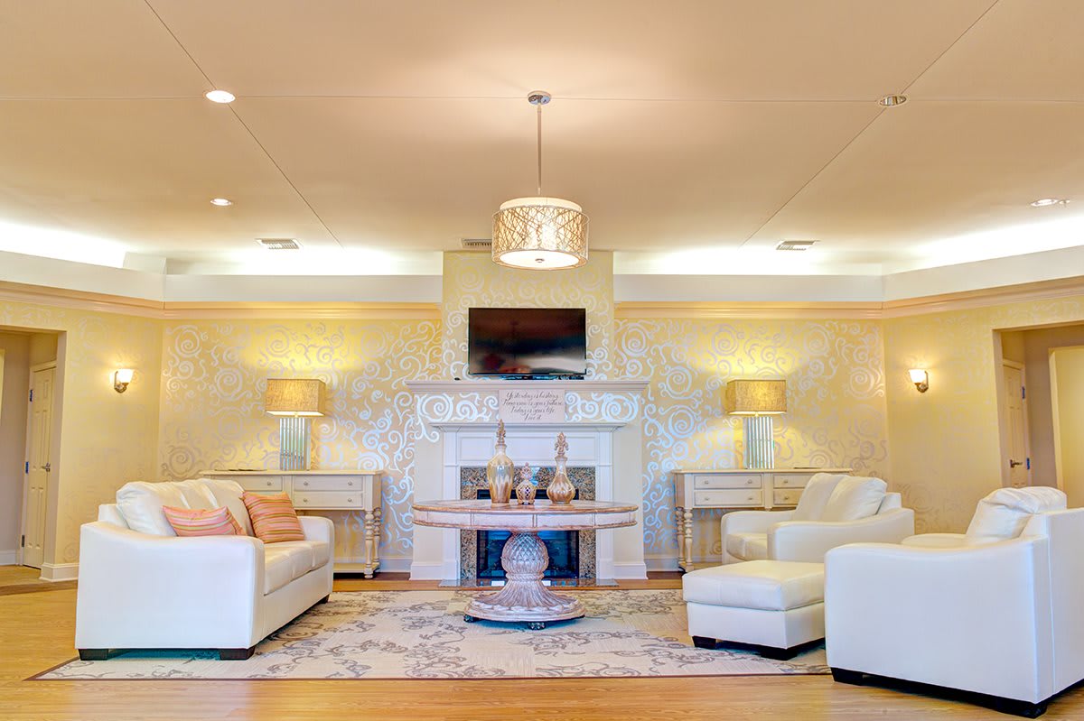A modern living room with elegant furniture and a cozy fireplace.