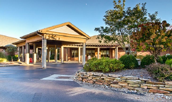 A well-landscaped building entrance with a modern architectural design.