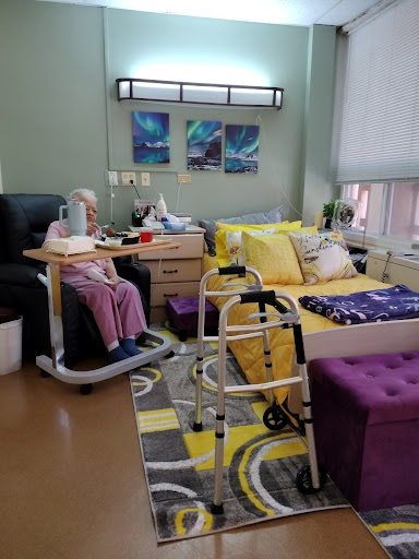 A cozy hospital room equipped for patient care and rehabilitation.