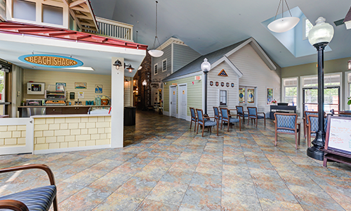 A creatively designed indoor space resembling an outdoor street, complete with seating and decorative structures.