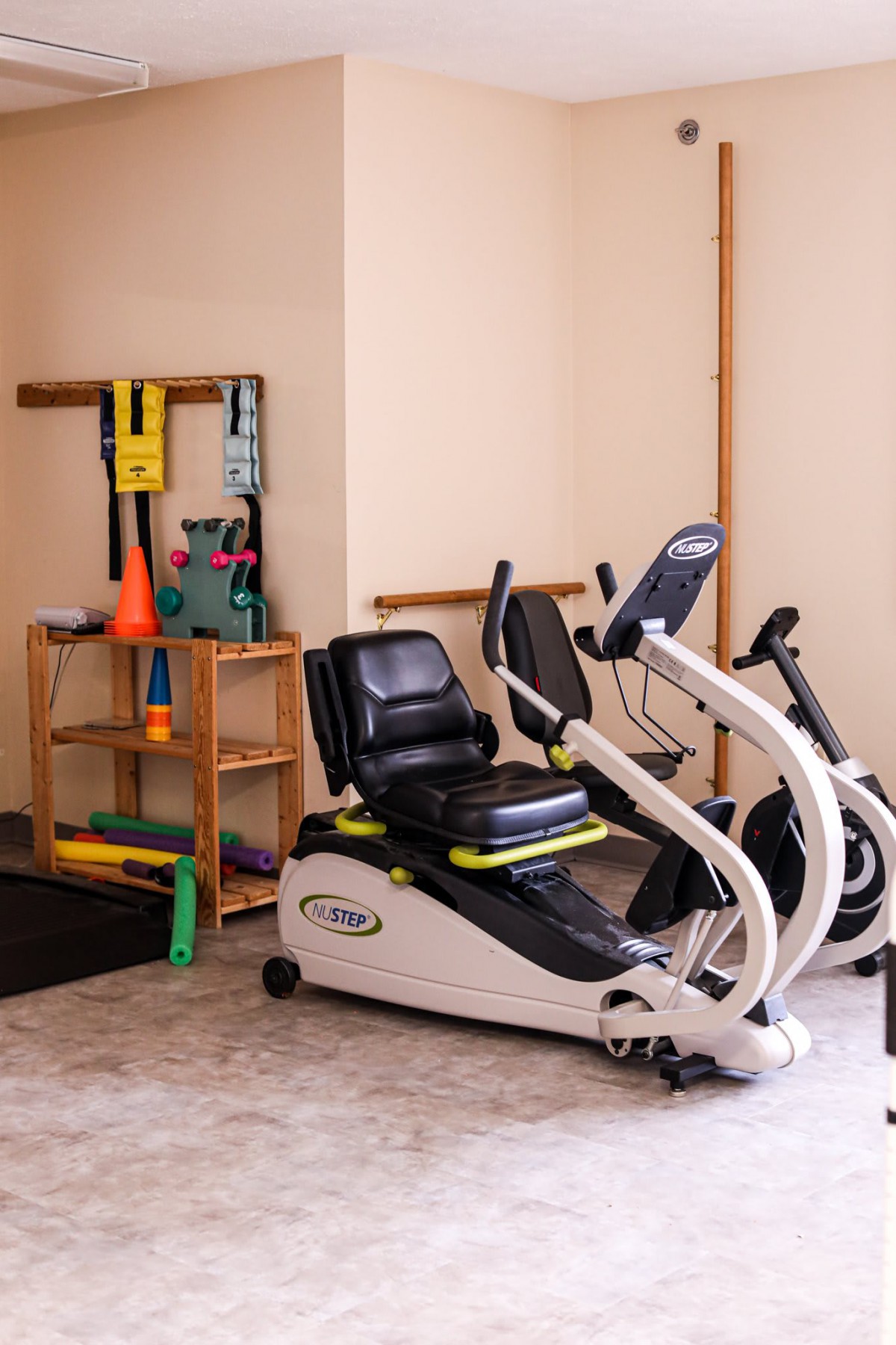 A small gym area equipped with stationary bikes and assorted exercise tools.