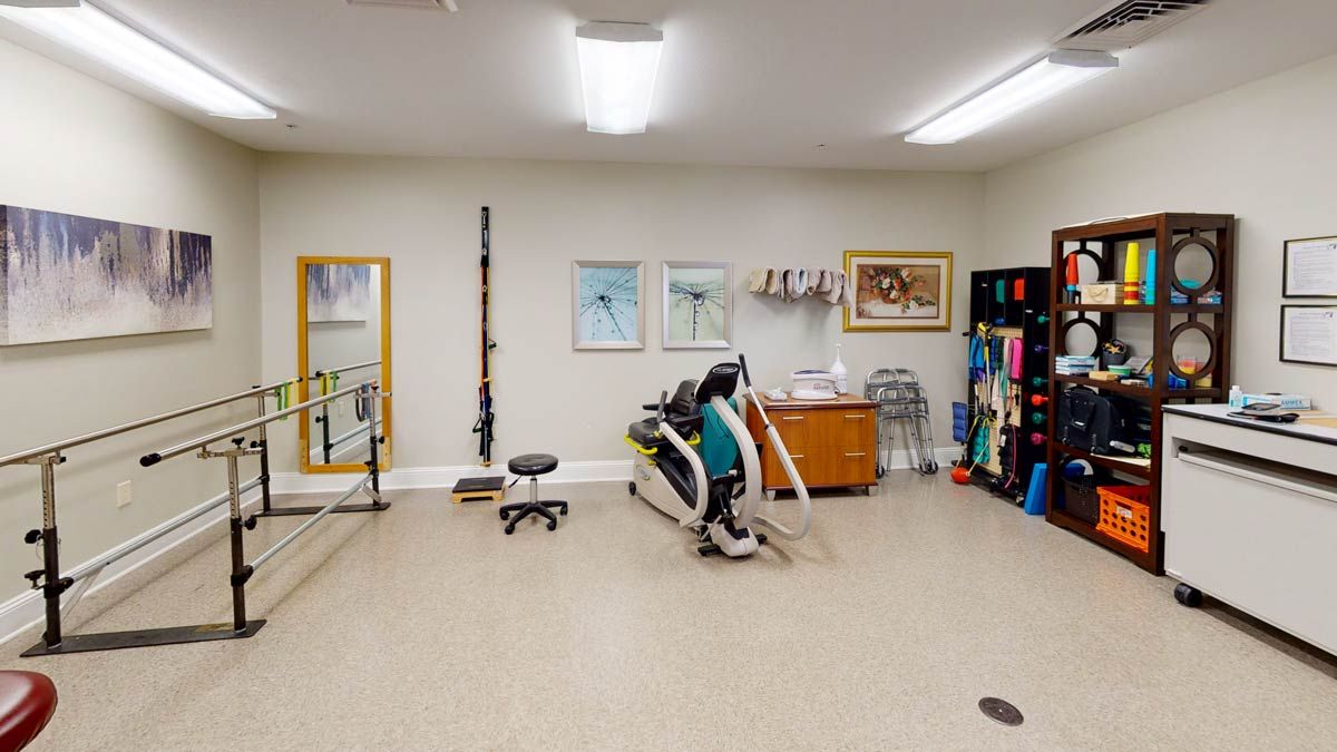 A well-equipped gym room with various exercise machines and fitness gear.