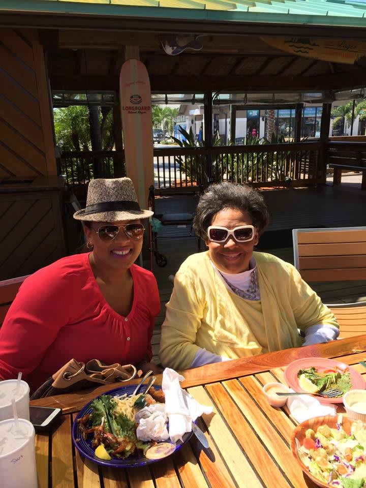 Two people enjoying a meal outdoors at a restaurant.