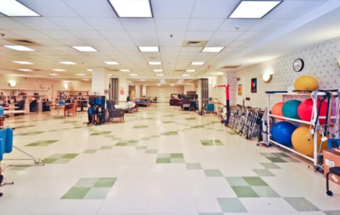 A spacious store interior displaying various furniture items with tile flooring and bright lighting.