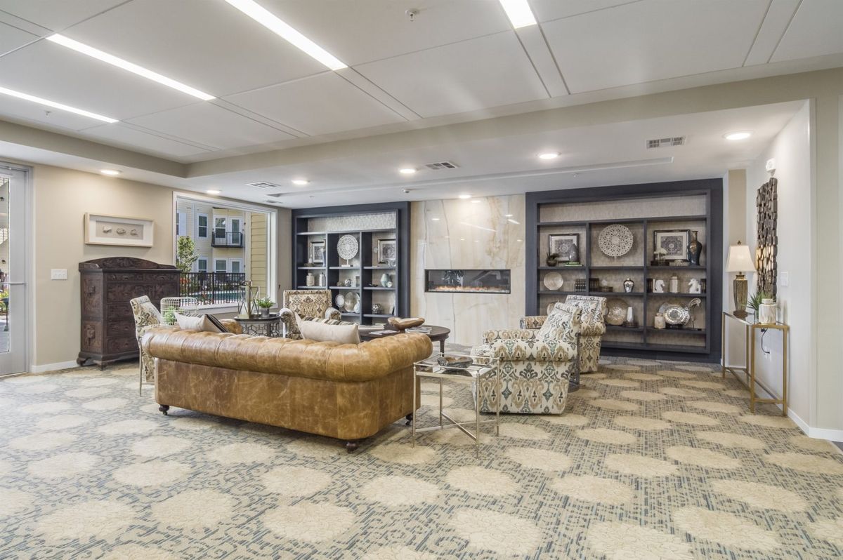 A modern living room with stylish furniture and decorative bookshelves.