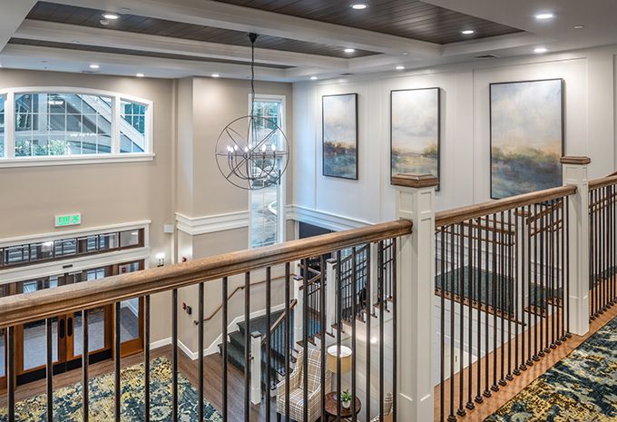 A modern, elegantly designed interior featuring a stylish staircase and contemporary artwork.